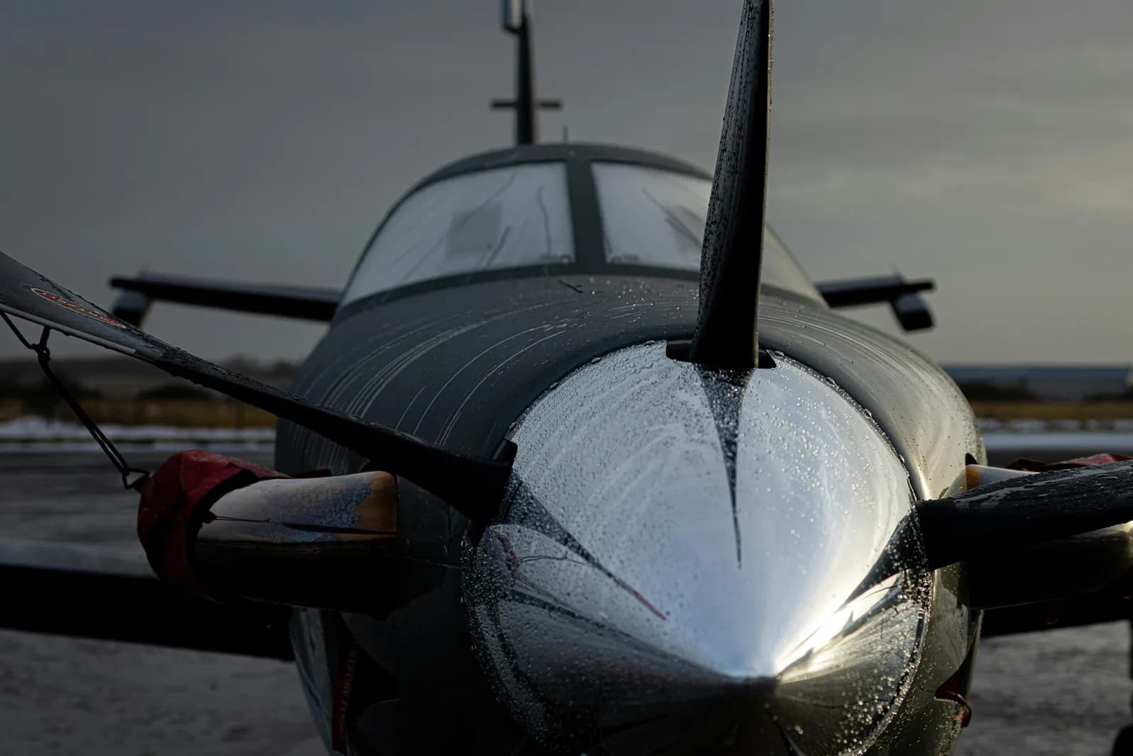 Private jet parked on a hangar tarmac with polished aluminum and clean fuselage